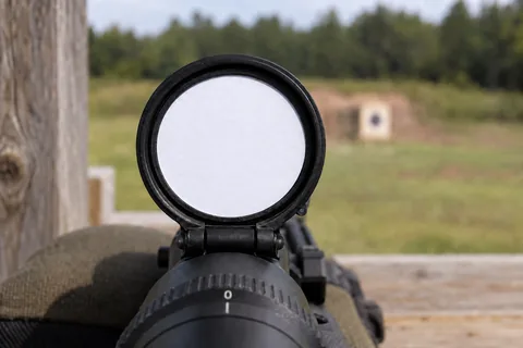 Circular two-column reference card fitted inside an open black scope cap